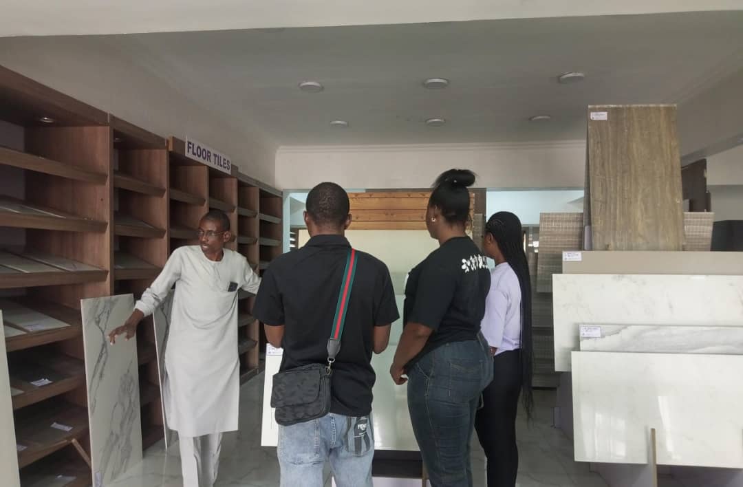 Students choosing tiles at a showroom