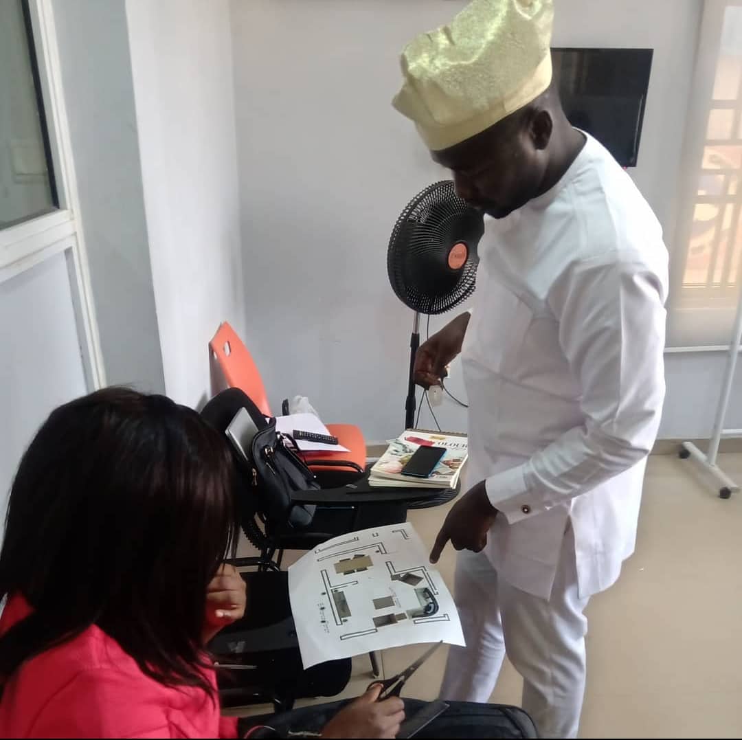 A tutor reviewing a floor plan with students